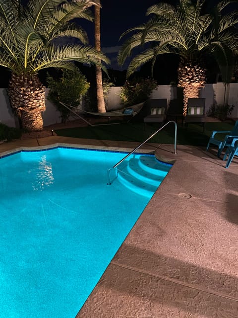 Beautiful blue pool with professional night lighting 