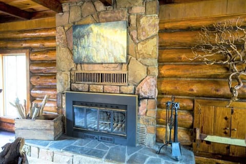 A genuine stone hearth fireplace with plenty of wood to keep you warm.