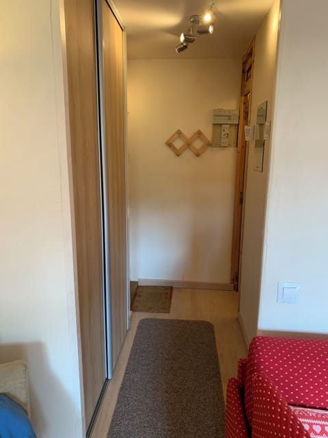 hallway with sliding wardrobe doors on the left, bathroom and separate toilet. 
