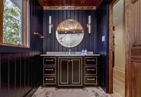 [Primary Bathroom] The Master Bathroom is Styled with Exquisite Finishing Touches and a Sleek Design Perfect for Relaxation After a Fun Day on the Lake. 
