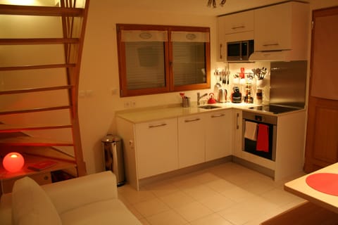 Main living area showing sofa and staircase to mezzanine
