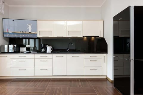 White furniture and high-quality appliances ensure a comfortable stay with the possibility of cooking meals.
