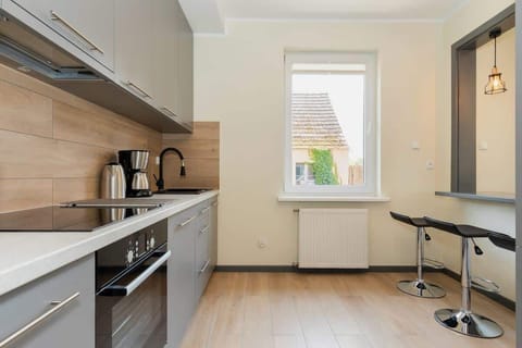 Kitchen with oven and refrigerator. 