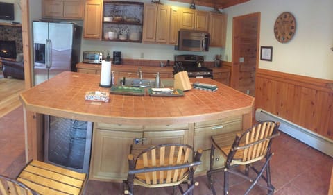 View of kitchen with wine cooler, bottom left, and convection oven