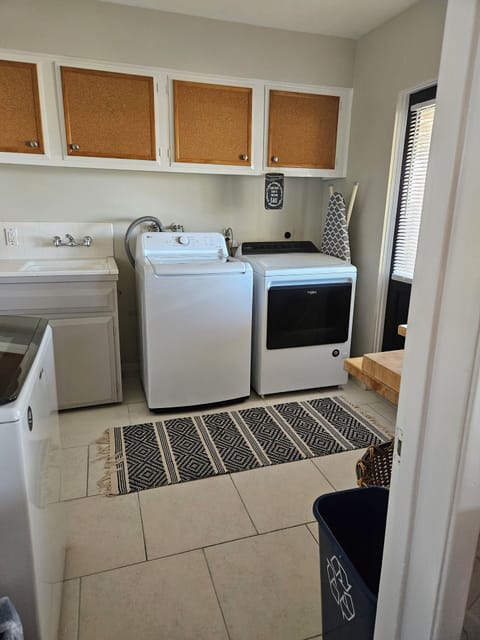 New washer & dryer with folding table and ironing board. 