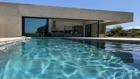 A heated pool, sun loungers