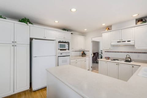 Kitchen with fridge, microwave, and oven.