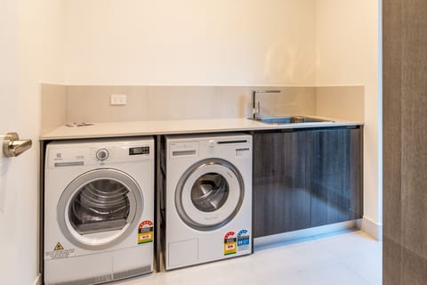 Fully equipped laundry with new appliances.