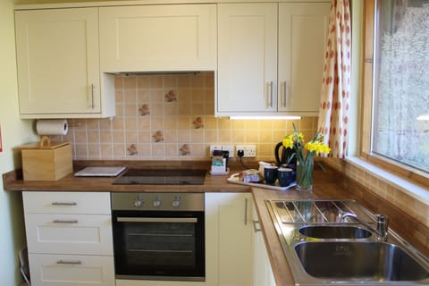 Bright, light, kitchen with dishwasher, oven & grill, ceramic hob, fridgefreezer