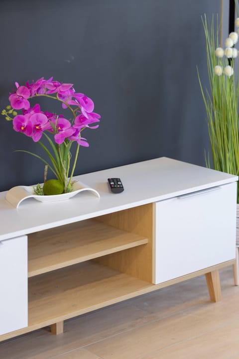 A delicate close-up of a vibrant bouquet of purple flowers, elegantly placed on a wooden surface, adding a touch of freshness and natural beauty to the interior.