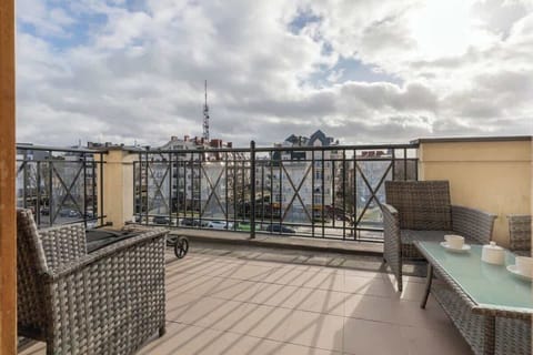 A small balcony or terrace with a cozy seating area, providing an outdoor space to enjoy the surrounding views and fresh air.