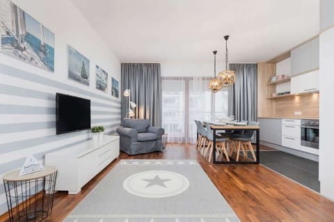 On the living room floor lies a grey soft carpet which creates a cosy atmosphere.