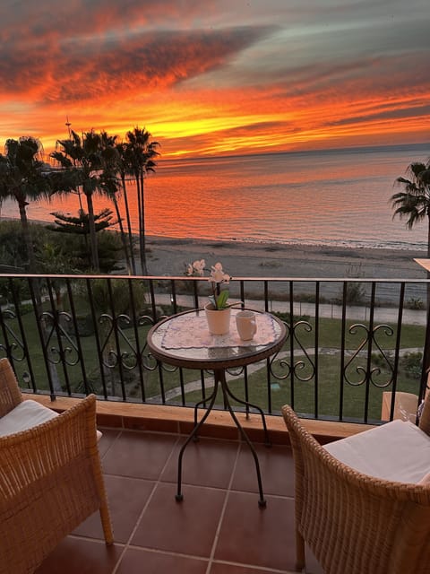 A cup of tea or coffee at sunrise. In front is the "the private" beach