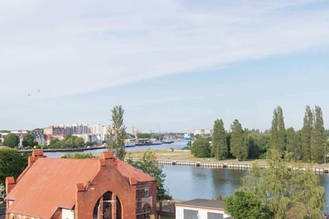 An angled view of a balcony with a railing, overlooking neighboring houses or buildings.