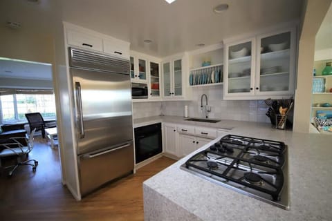 Large built-in Fridge, cabinets filled with cooking needs. New countertops