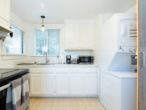 Located behind a clever laundry door is a full-size washer and dryer.
