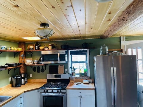 Aspen ceiling beams add character to the kitchen, open to the dining area.