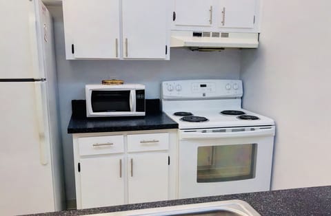 Microwave, dishwasher, coffee/tea maker, cookware/dishes/utensils