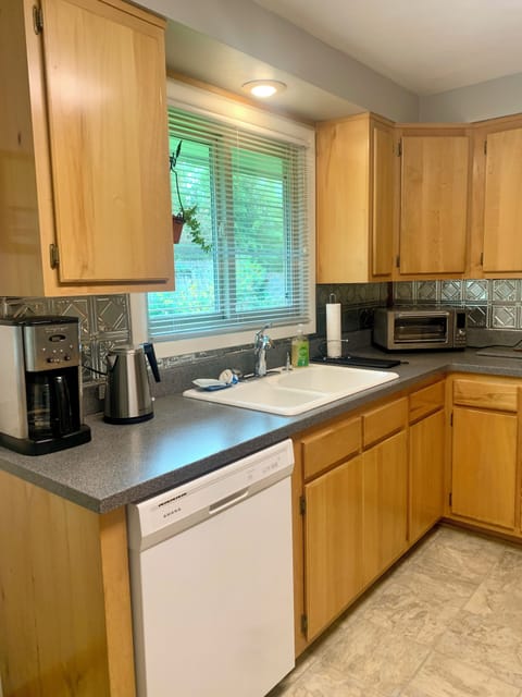 Super-equipped kitchen -- appliances, cook- and serveware, spices, staples, etc.