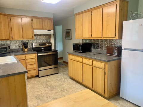 Glass top range, Beko fridge,a microwave, -- and an antique stereo AM/FM radio!