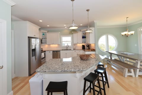 Kitchen with stainless appliances, granite counter tops, and a center island