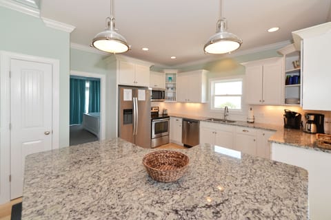 Kitchen with stainless appliances, granite countertops, and a center island