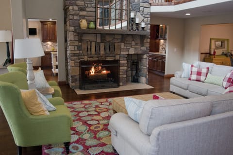 Large great room has enormous real wood burning fireplace.  Pool access!