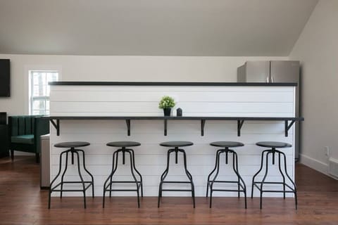 Sleek bar seating for five with modern stools, perfect for dining or entertaining.