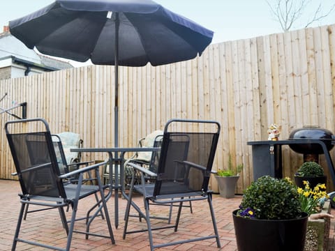 Sitting out area on the patio | The Snug, Caergeiliog, near Holyhead