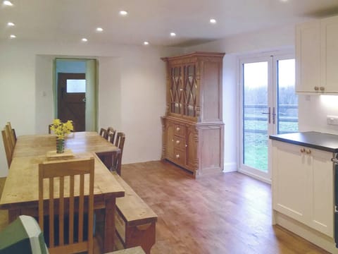 Large dining area with double doors to garden | Tutchenor Farmhouse, Patchacott, near Beaworthy