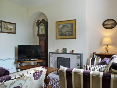 Homely living room with open fire | Howe Bridge House, near Portinscale