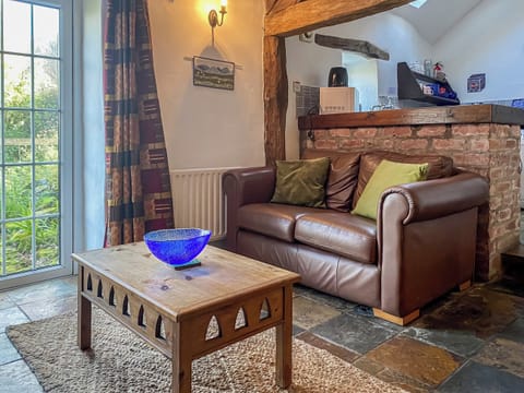 Tile-floored living space with access to the garden | Birkerthwaite Stable - Birkerthwaite Cottages, Eskdale