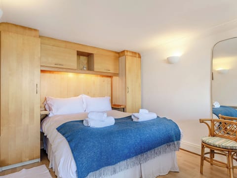 Comfortable double bed with built-in wardrobes for ample storage | Studio Sea Urchin, Carbis Bay, near St Ives