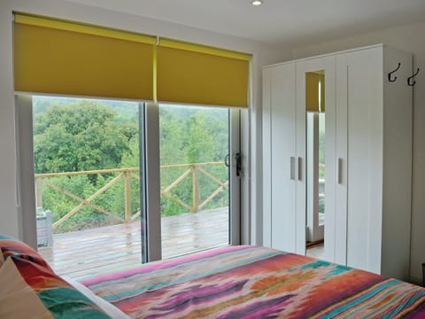 Comfortable double bedroom with doors leading to patio | The Shed with a View, Cadbury, near Crediton