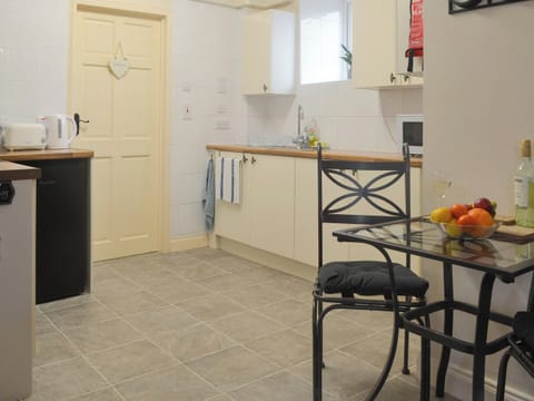 Well-equipped kitchen | The Snug - Ty Copr, Pen-y-Sarn, near Amlwch