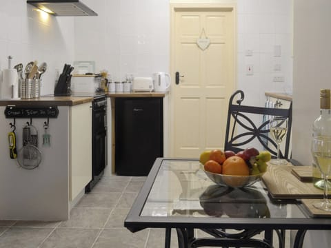 Convenient open-plan kitchen  | The Snug - Ty Copr, Pen-y-Sarn, near Amlwch