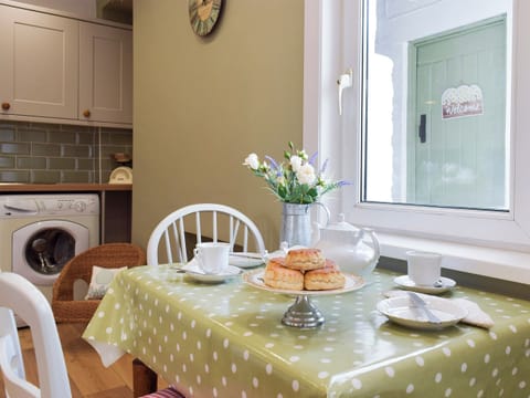 Galley style kitchen with breakfast bar | Moss Cottage, Burry Port, near Llanelli