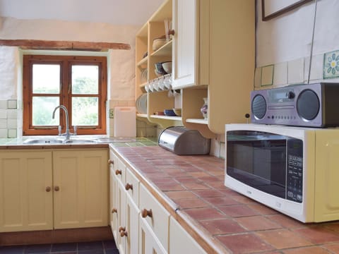 The kitchen/diner boasts tiled worktops and quarry-tiled floor | Lordship FarmhousePottery, Wolfscastle, near Haverfordwest