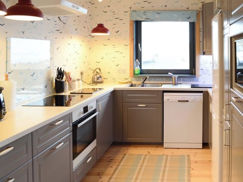 Stylish wood-floored kitchen area | Fionn Croft Lodge, Melvaig, near Gairloch