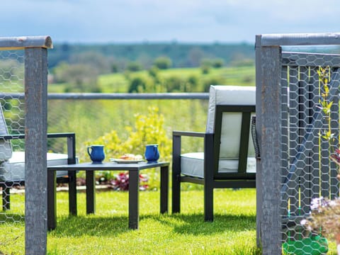 Beautiful new back garden, with spectacular views over the Peak District and comfortable lounge furniture | Bailey’s Barn, Bonsall, near Matlock