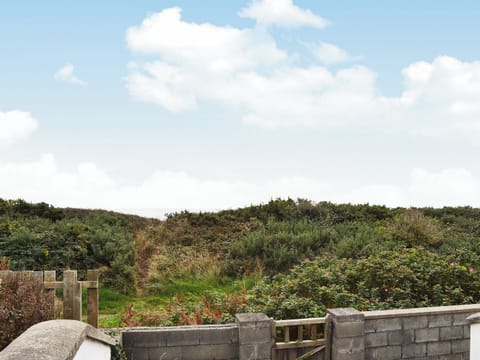 Sea view from the decked area with access to coastal path | Glan-Mor, Pwllheli