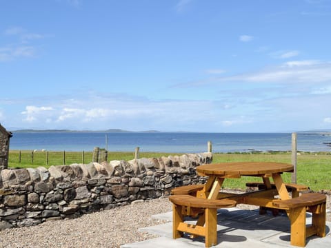 Outdoor seating area with fantastic views | Charlie’s Cottage, Muasdale, near Campbeltown