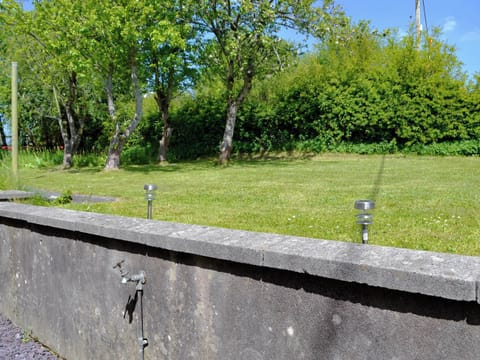 Lawned garden | The Mill Farmhouse (Ty Fferm Y Felin), Llandybie, near Llandeilo