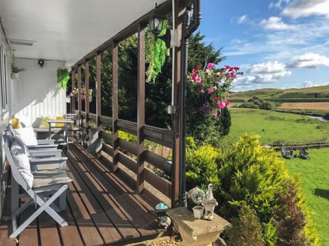 Sit out and relax on the covered porch in all seasons | Harperfield Chalet, Lanark