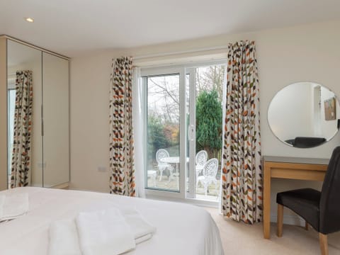 Dressing area of double bedroom with door to patio area | Little Woodlands, Alnmouth, near Alnwick
