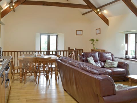 Exposed wood beams and wooden floors throughout living area | Cider Barn - Burracott Farm, Poundstock, Bude
