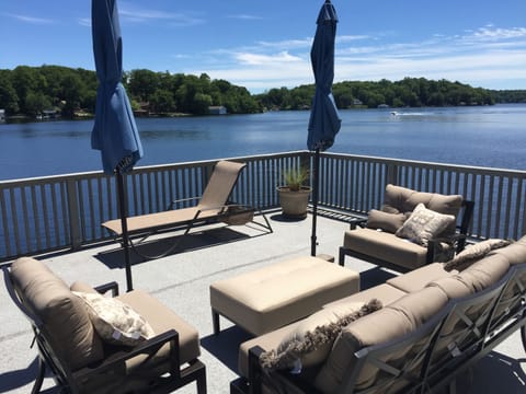 Deck on Boathouse literally extends over the lake.  Comfy new furniture thru-out