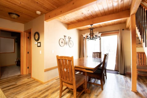 Dining Area- dining table has a bench on one side and extends out to fit 10