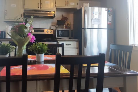 Fully equipped kitchen and large sit in dining area view to park