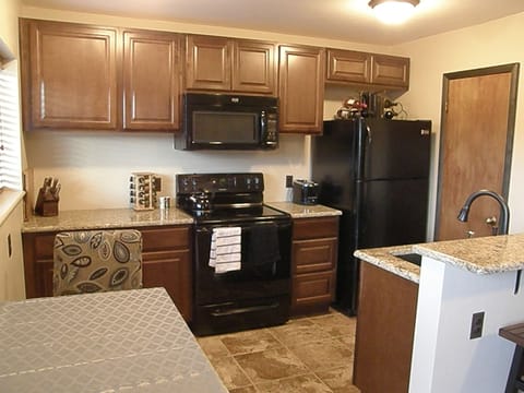 View of the kitchen with granite counters, upgraded cabinets, heated floor, etc